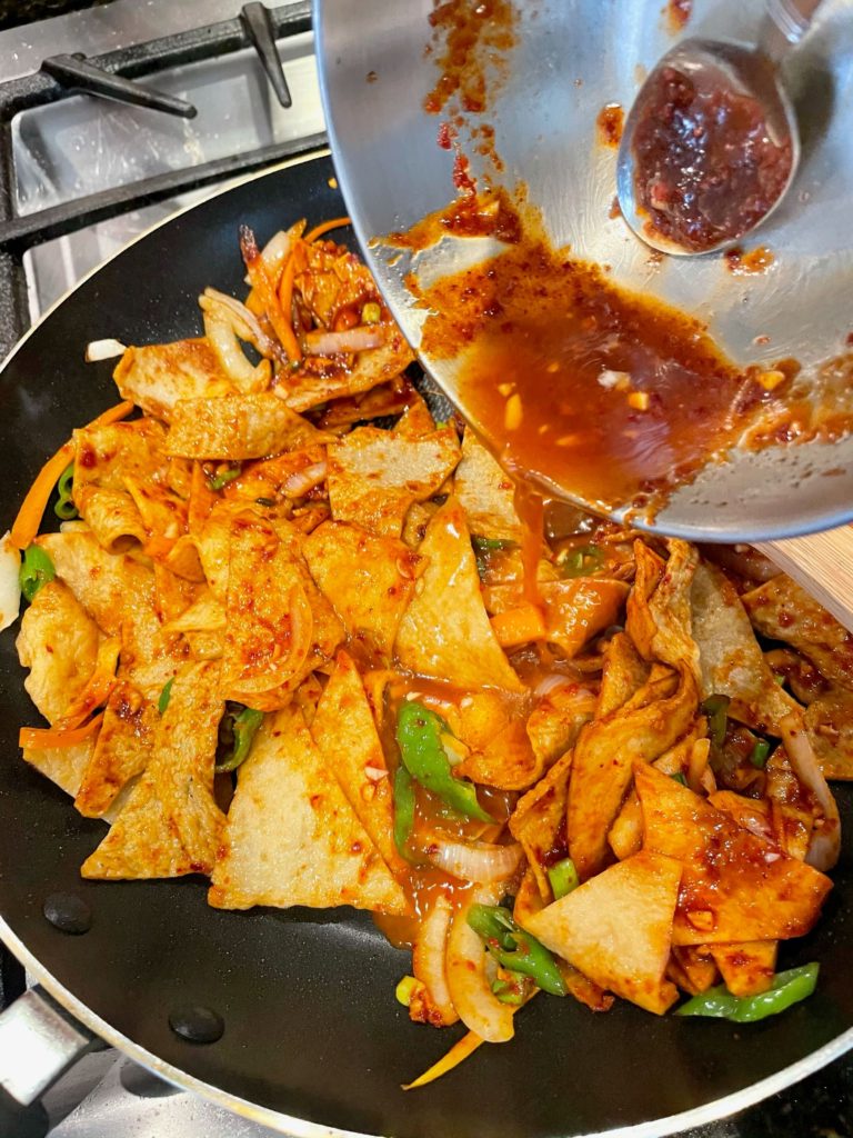 spicy sauce added into eomuk bokkeum