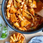 tteokbokki cooked and served on a hot pan with spoon