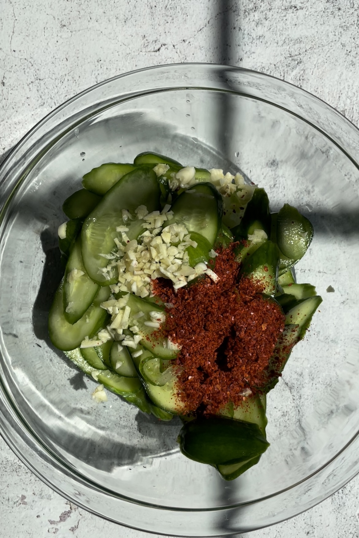 sliced cucumber with garlic and gochugaru on top