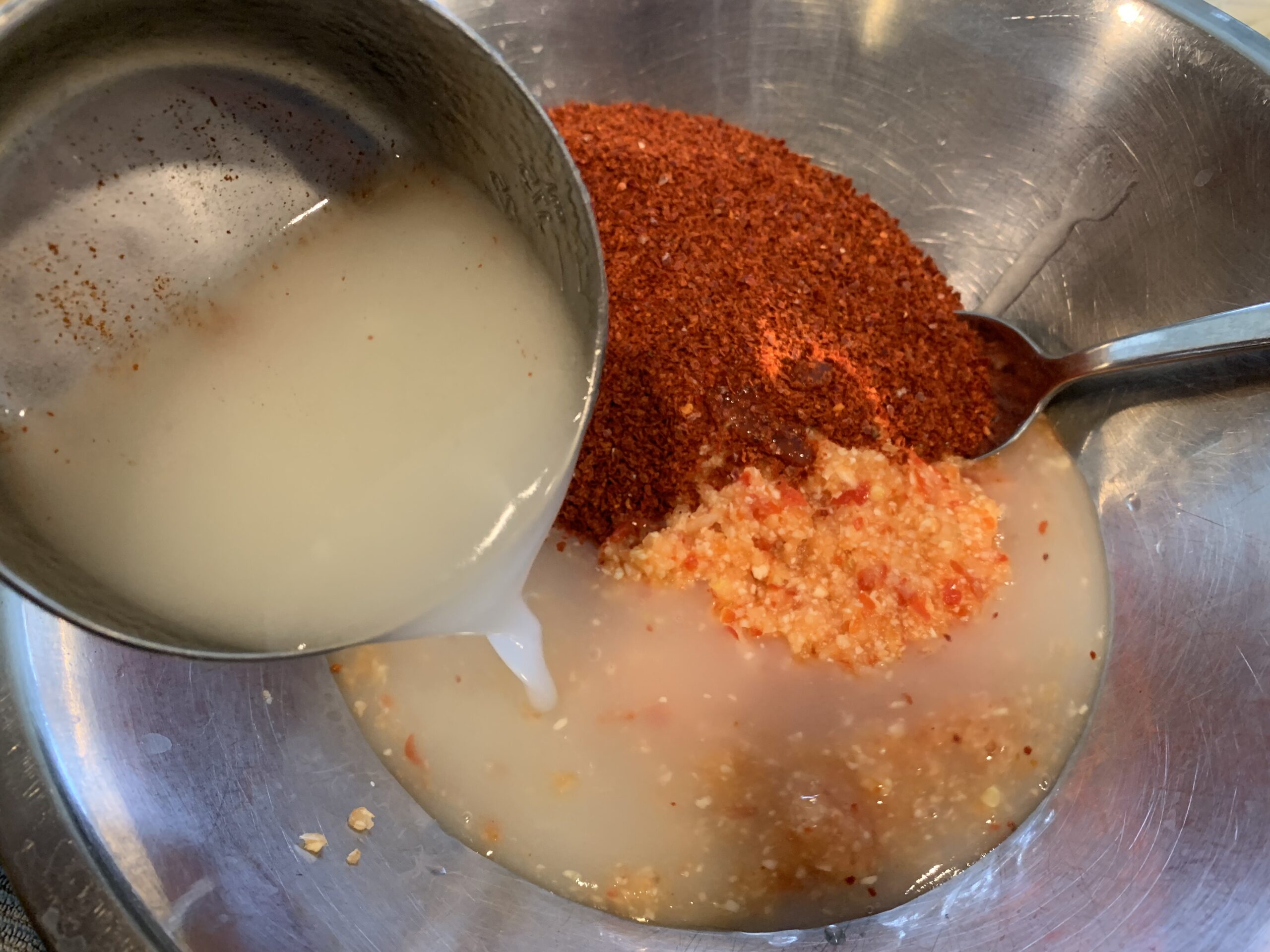 pouring rice paste into gochugaru