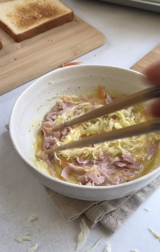mixing ham and cabbage into egg batter